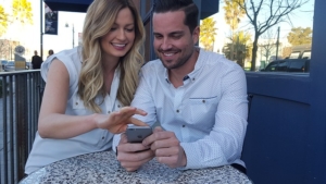 Man and woman smiling at mobile phone