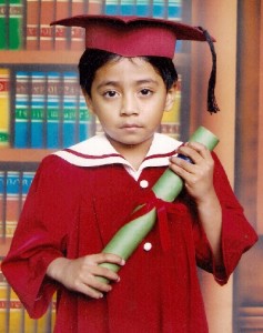 child with cap, gown, diploma